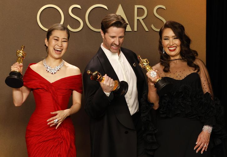 From left, Michelle L.M. Wong, Chris Appelhans and Maggie Kang pose with the award for Best Animated Feature Film for 'KPop Demon Hunters' during the the 98th annual Academy Awards ceremony at the Dolby Theatre in Los Angeles, March 15. EPA-Yonhap