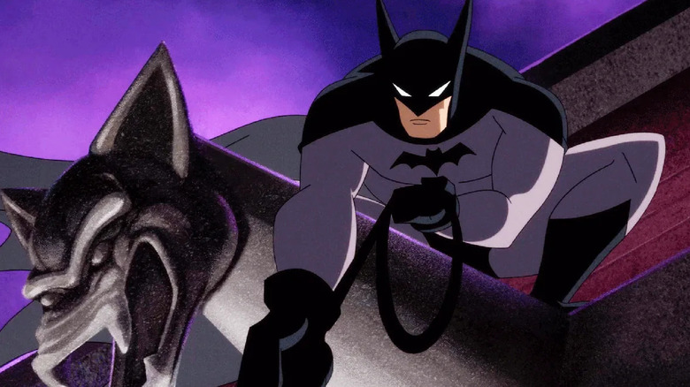 Batman crouched on top of a gargoyle, reeling in a rope, on the animated series Batman: Caped Crusader.