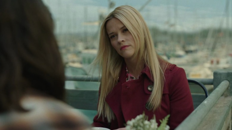 Madeline (Reese Witherspoon) sitting at a café table and listening to Jane (Shailene Woodley) on Big Little Lies S1E4