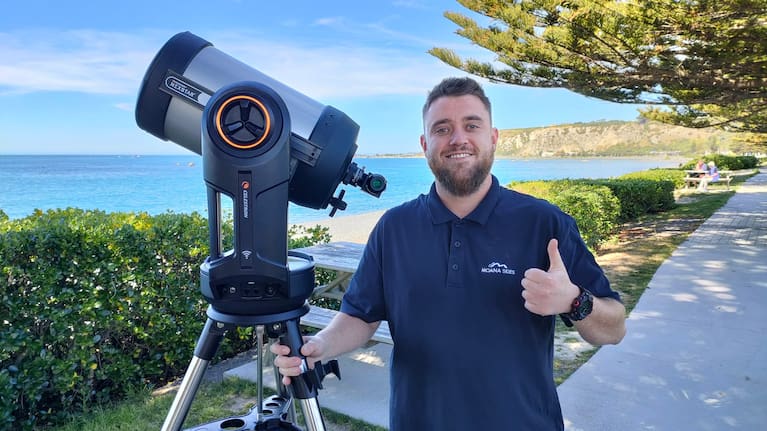 Bradley McConville sets up his solar telescope along the Kaikōura beachfront for viewing the sun.