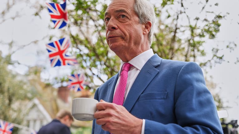 Nigel Farage, the leader of Reform UK, drinks a cup of tea as he meets supporters after a news conference in London on April 2, 2026