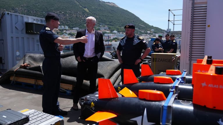 Britain's Armed Forces Minister Al Carns, centre, inspects autonomous vehicles with sonar sensor that can detect and identify mines, on RFA Lyme Bay in territory of Gibraltar, on Friday, May 22, 2026.
