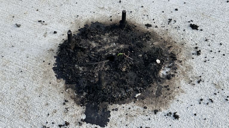 Burnt remains of wiring where the camera had been knocked from its base.
