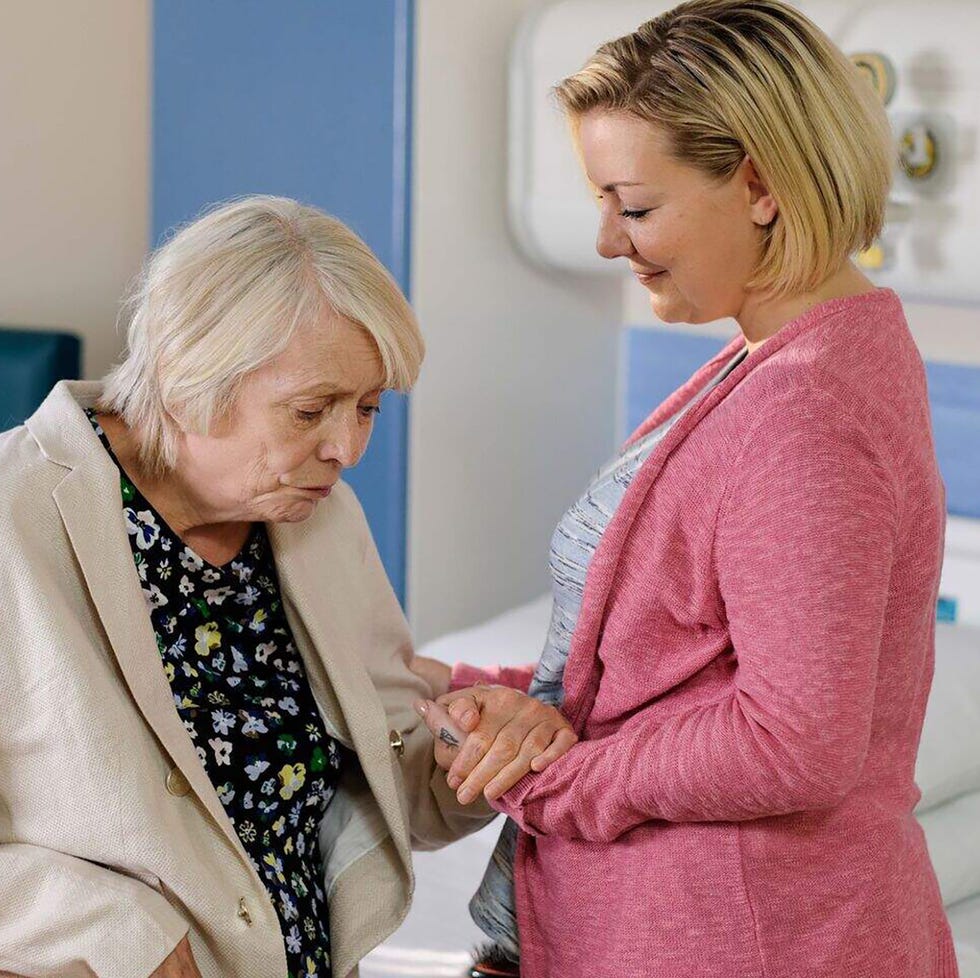 two women in a hospital setting engaged in a tender moment two women in a hospital setting engaged in a tender moment