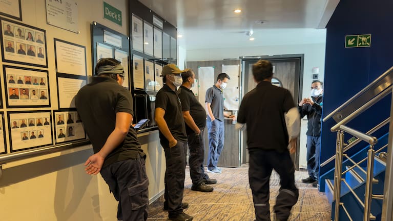 Crew members of the hantavirus-stricken cruise ship, MV Hondius, wait their turns for a first interview with epidemiologists, during the voyage to Spain's port of Tenerife, May 6, 2026