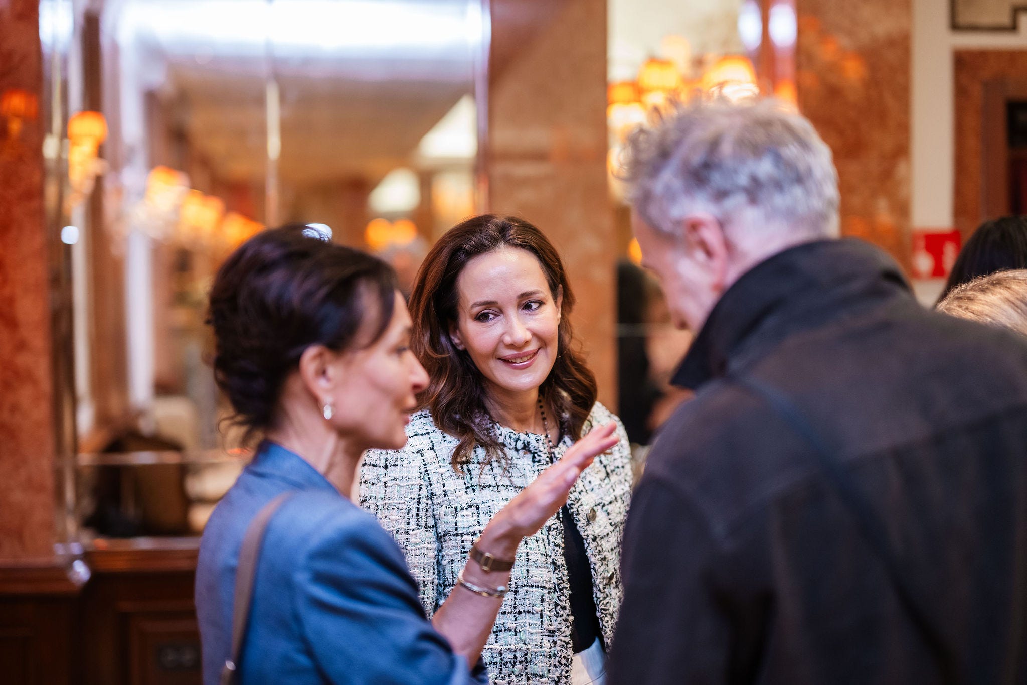 Group of people engaged in conversation indoors