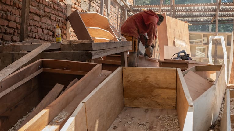David Zaki, 19, makes a coffin at a carpentry shop in the Congo.