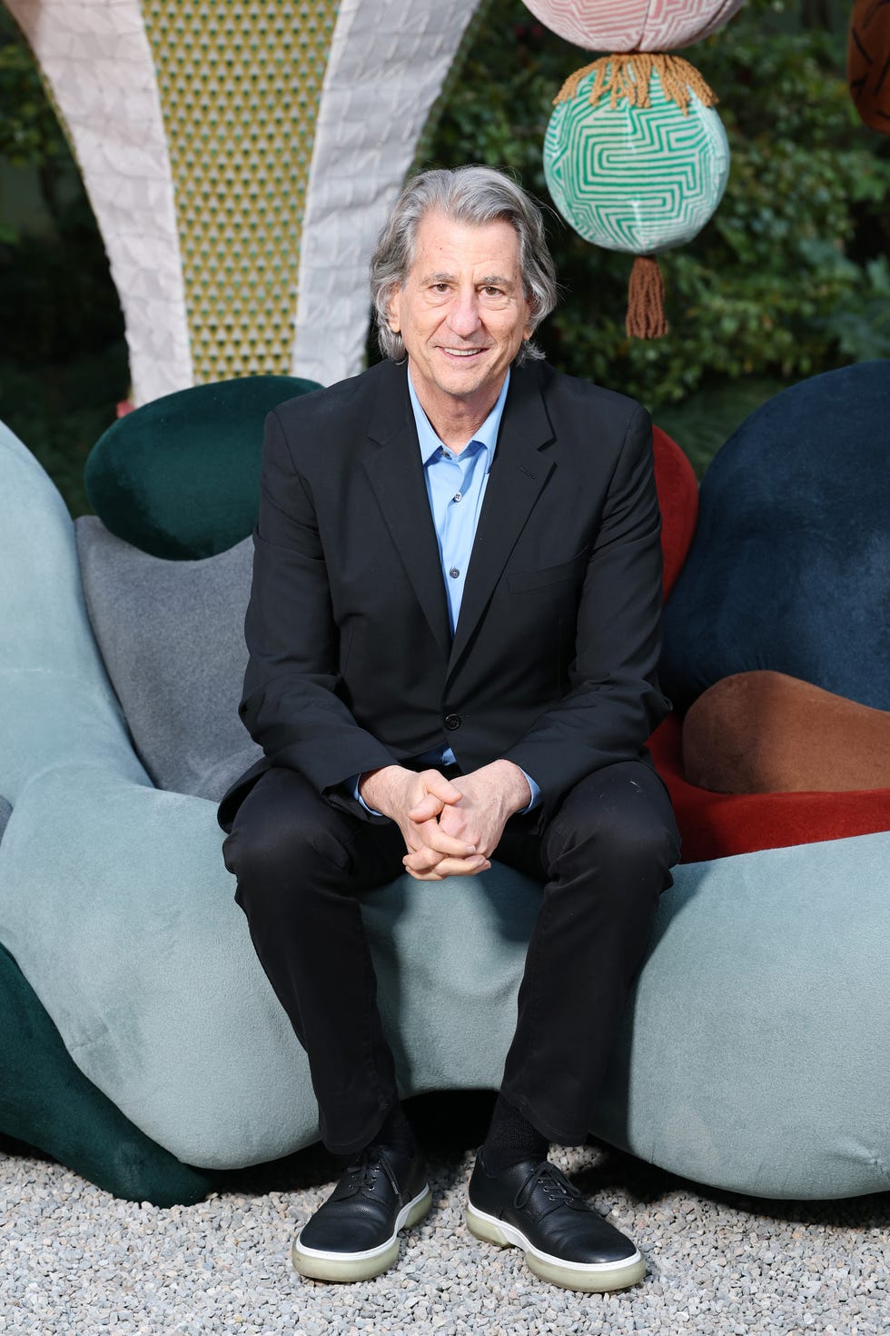 Architect and designer David Rockwell against a colorful background