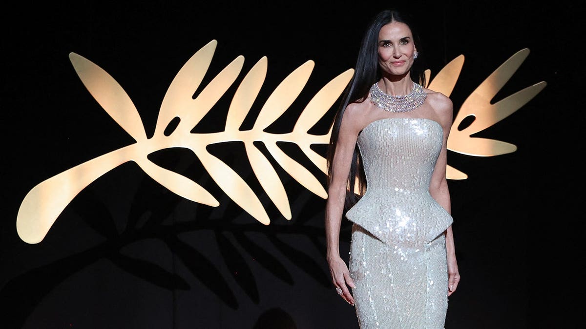 Demi Moore arriving on stage at Cannes Film Festival opening ceremony