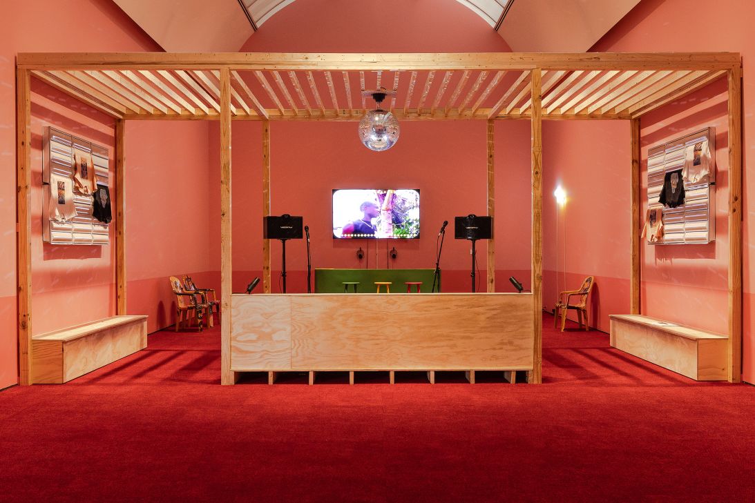 Soto’s chairs flank the walls of one of the rooms in the exhibition “Dancing the Revolution” that is staged as a karaoke bar.