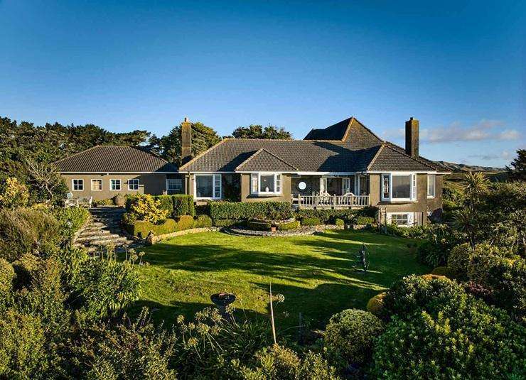 A 742ha coastal farm in Porirua with four dwellings and its own private beach has sold for an undisclosed price. Photo / Supplied