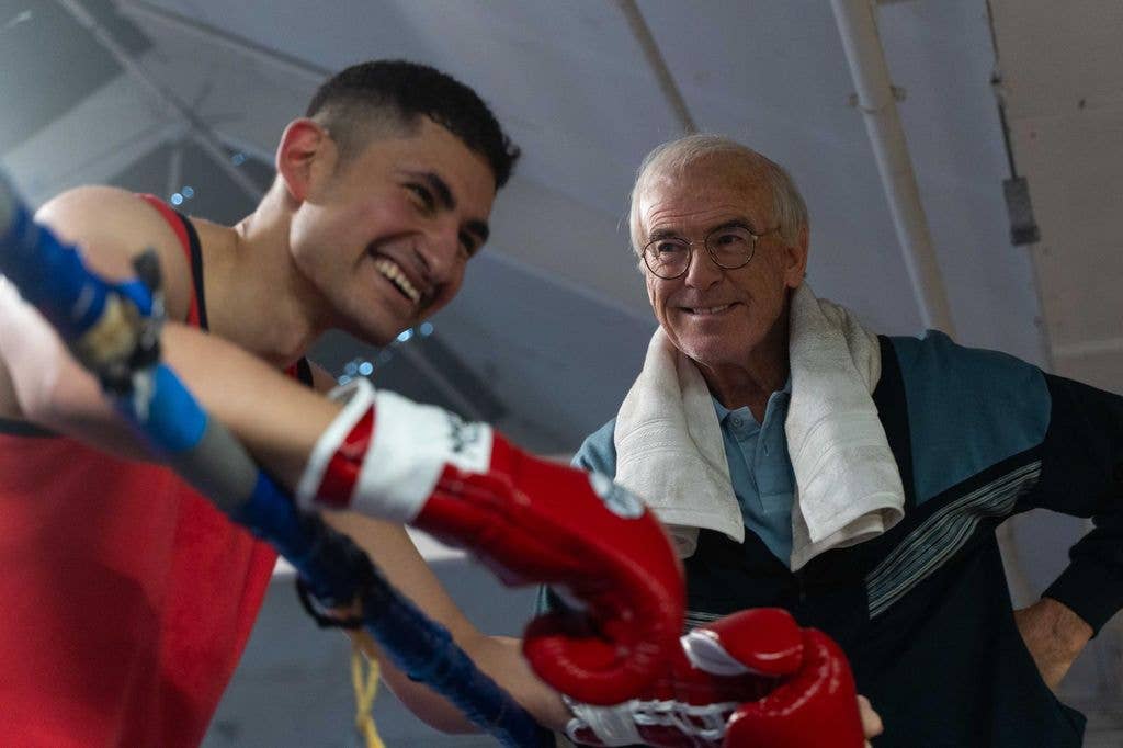 boxer in ring next to coach