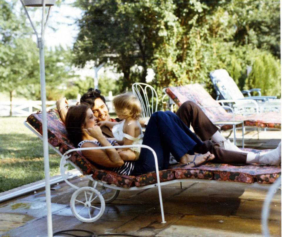 Priscilla, Elvia, and baby Lisa Marie relax at home.