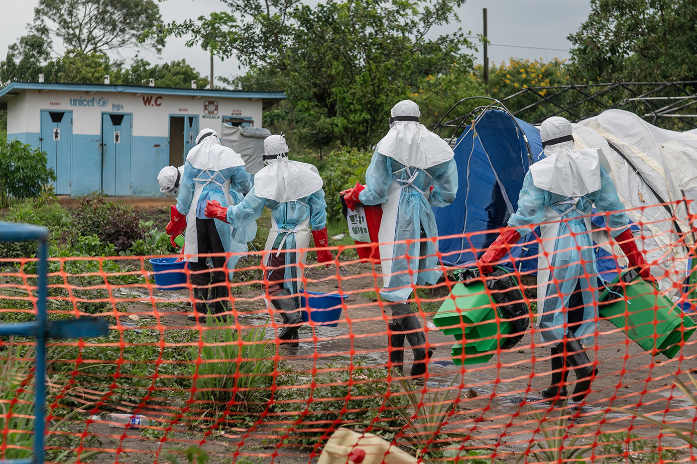 Health workers in full protective gear entering an Ebola treatment center in Rwampara, Congo.