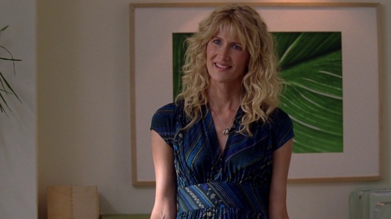 Amy (Laura Dern) standing in front of a framed picture of leaves on Enlightened S1E2