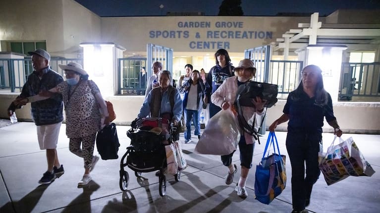 Evacuees from an aerospace chemical plant tank leak move to another shelter after the Garden Grove Sports and Recreation Center closed for the night in Garden Grove, California, Friday, May 22, 2026.