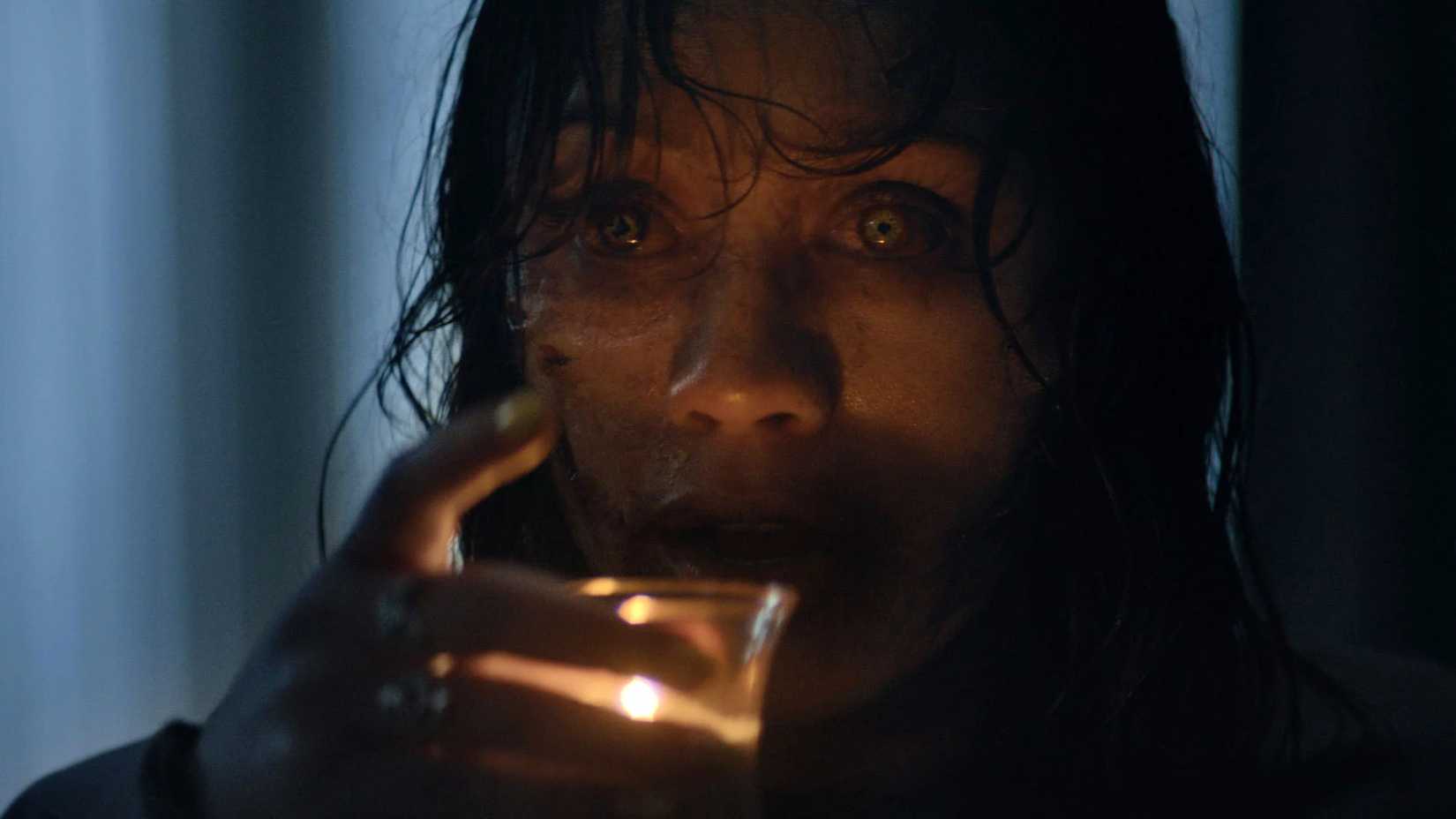 A Deadite From Evil Dead Burn Preparing To Drink Candle Wax
