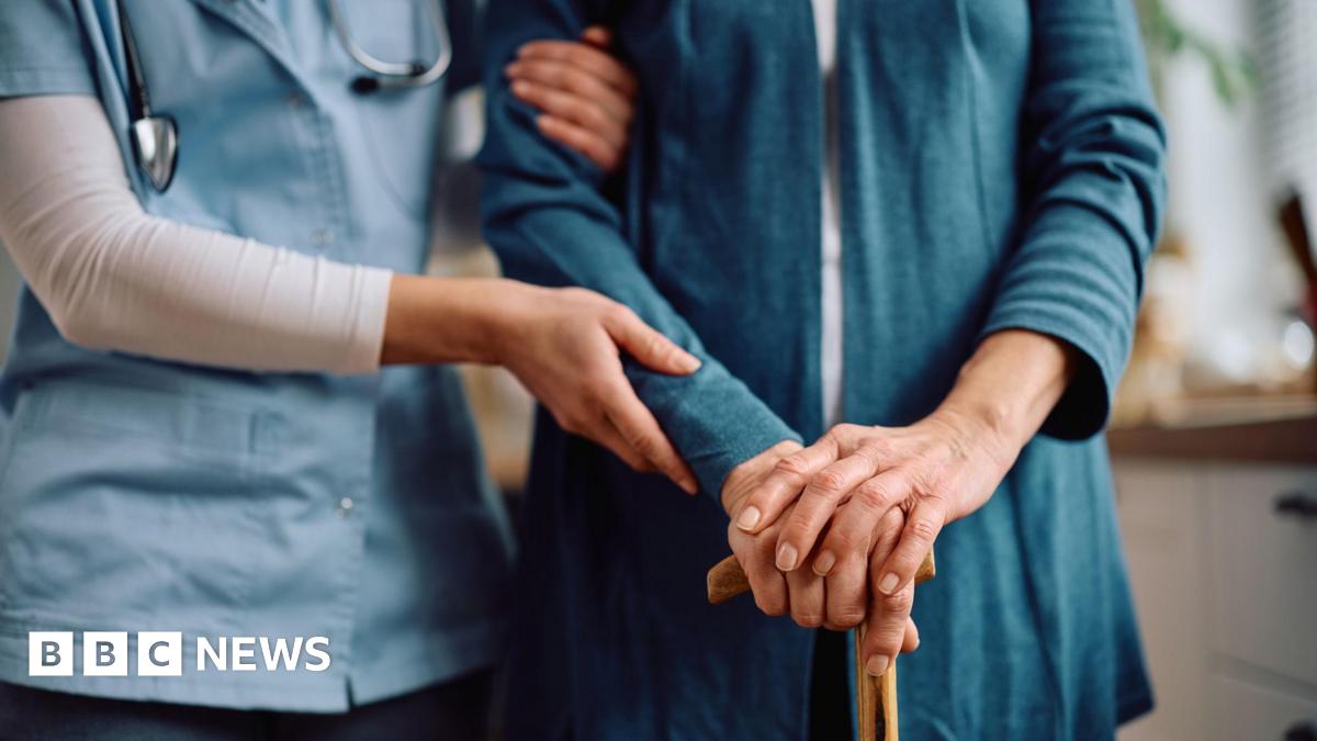 Close up of nurse and senior woman with walking cane during home visit.