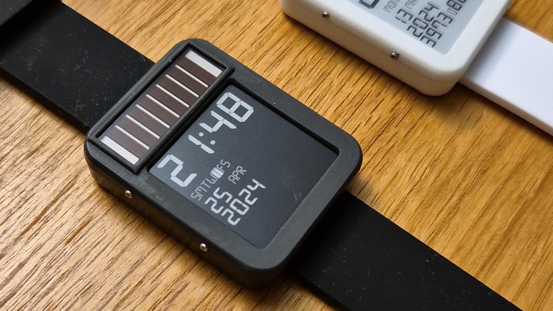 The LightInk solar-powered watch on a desk.