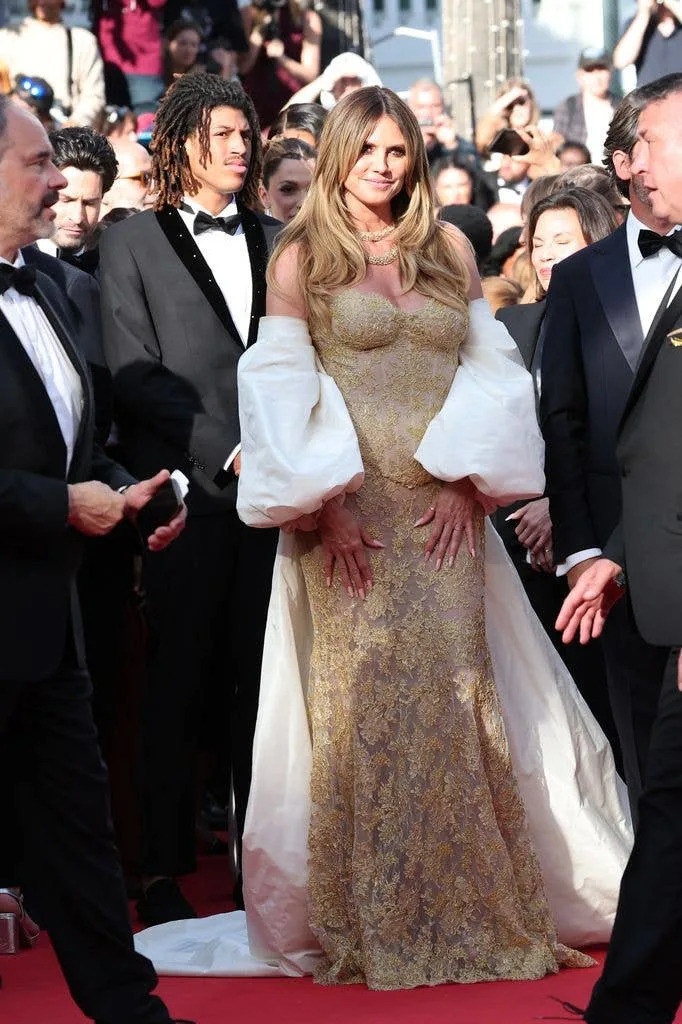 Heidi Klum in gold dress and her son Henry Samuel during the 79th annual Cannes Film Festival