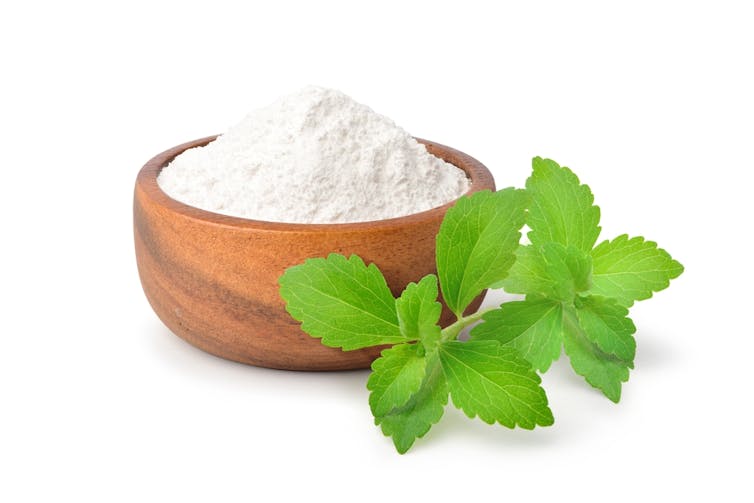 Stevia plant and sweetener in a bowl