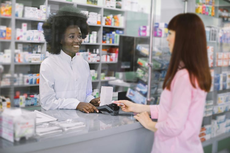 A pharmacist talking to a customer