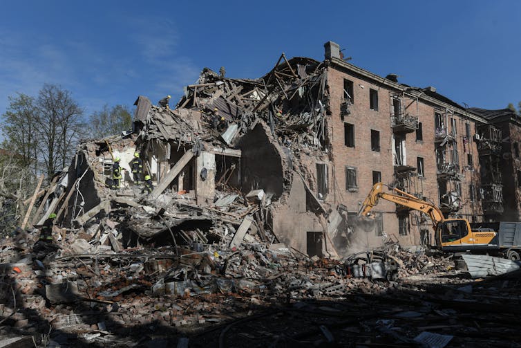 a heavily damaged four-storey building that has partially collapsed