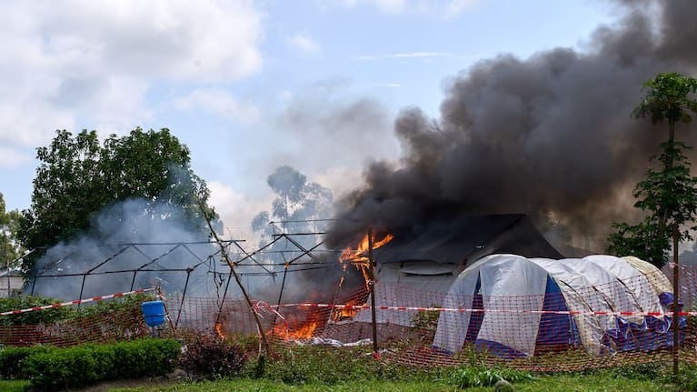 Flames and smoke rise from an Ebola treatment center in Rwampara, Congo, Thursday, May 21, 2026.