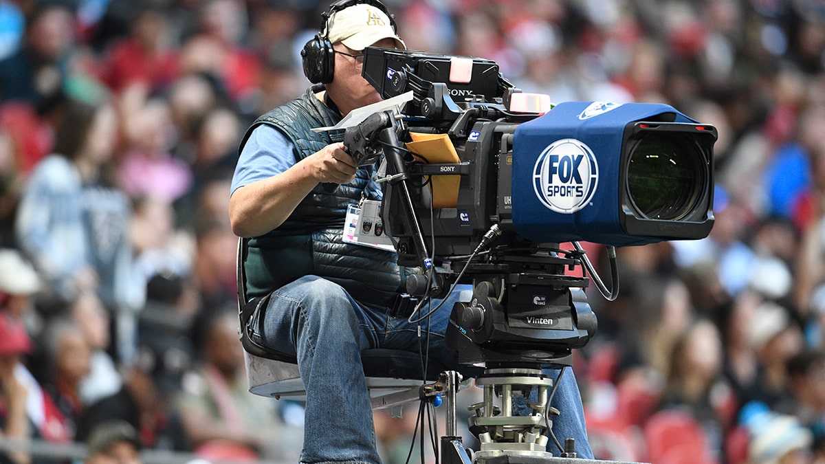 Fox Sports cameraman operating broadcast camera at Mercedes-Benz Stadium in Atlanta