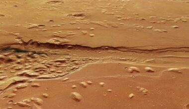 a deep, ragged trench carved into a reddish-orange landscape