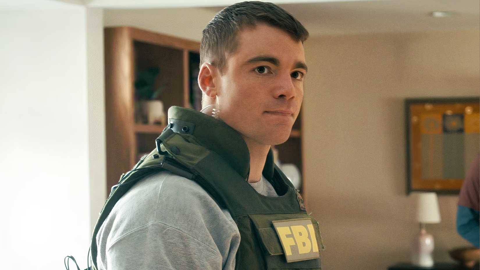 Gabriel Basso as Peter wearing an FBI vest in The Night Agent season 3