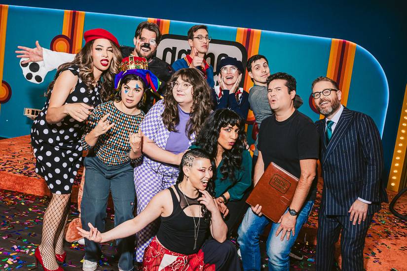 A group of 10 comedians and CEO Sam Reich pose together on the set of Game Changer season 8