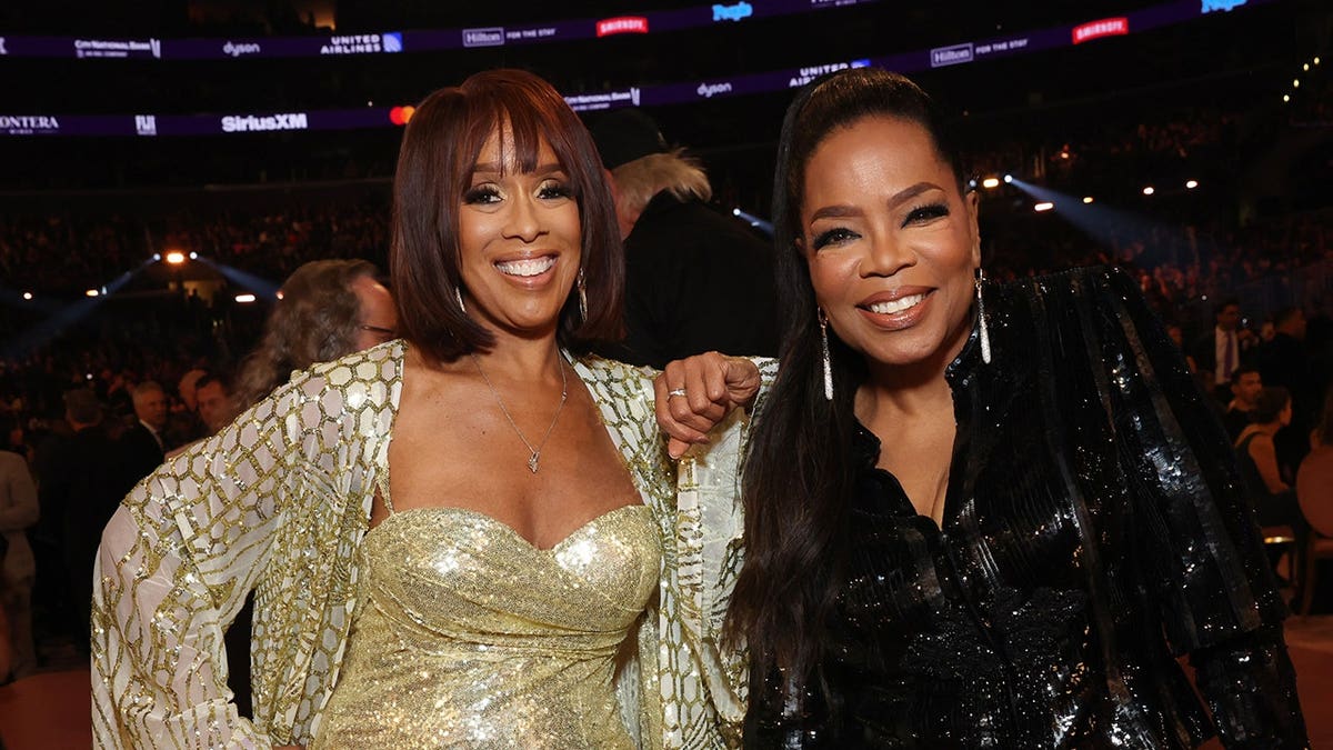 Gayle King and Oprah Winfrey standing together at the Grammy Awards in Los Angeles