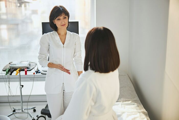 Medical worker discussing with patient in clinical setting