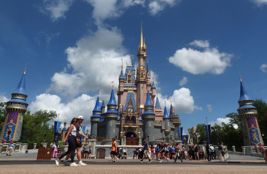 People walk past Cinderella Castle at Magic Kingdom at Walt Disney World in April 2025. Disney has noted