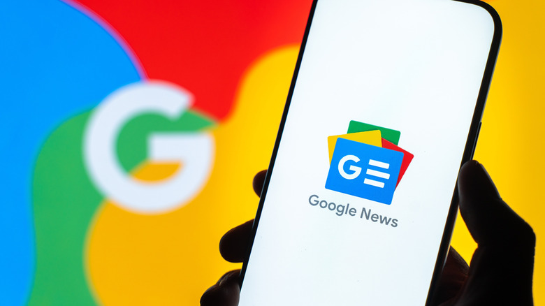 The Google News logo on a smartphone with the Google logo in the background
