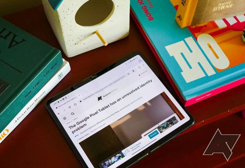 A Google Pixel Fold on a wooden table in tablet mode