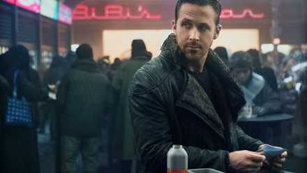 Ryan Gosling looks across a crowded room in Blade Runner 2049