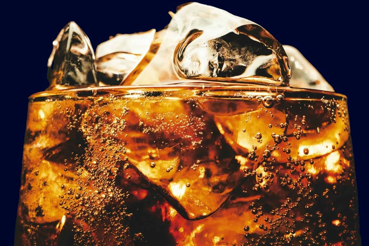 Close-up photo of a glass of coke with ice in it