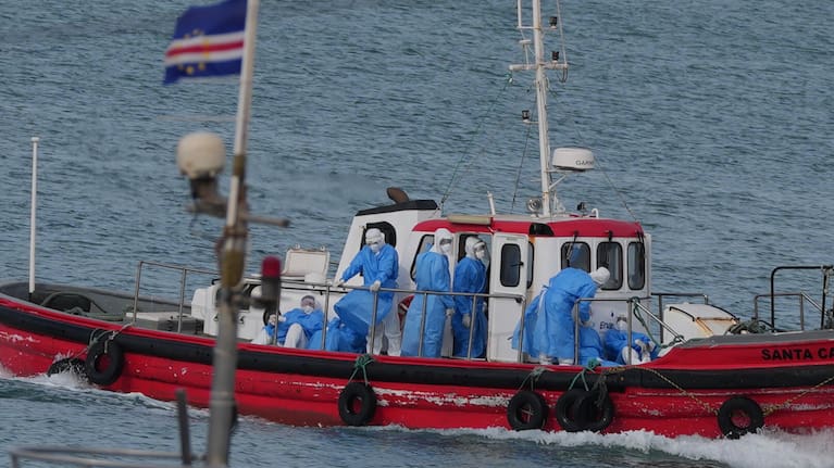 Health workers in protective gear arrive to evacuate patients from the MV Hondius cruise ship at a port in Praia, Cape Verde, Wednesday, May 6, 2026. 