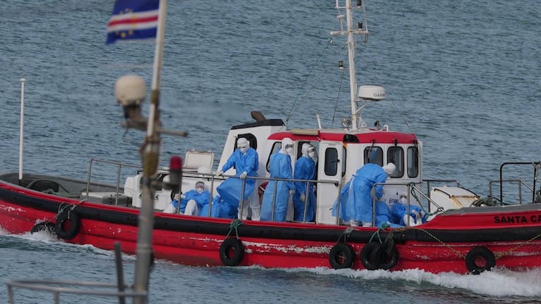 Health workers in protective gear arrive to evacuate patients from the MV Hondius cruise ship at a port in Praia, Cape Verde