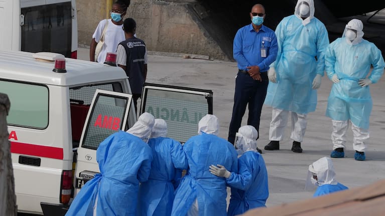 Health workers in protective gear evacuate patients from the MV Hondius cruise ship into an ambulance at a port in Praia, Cape Verde, Wednesday, May 6, 2026.