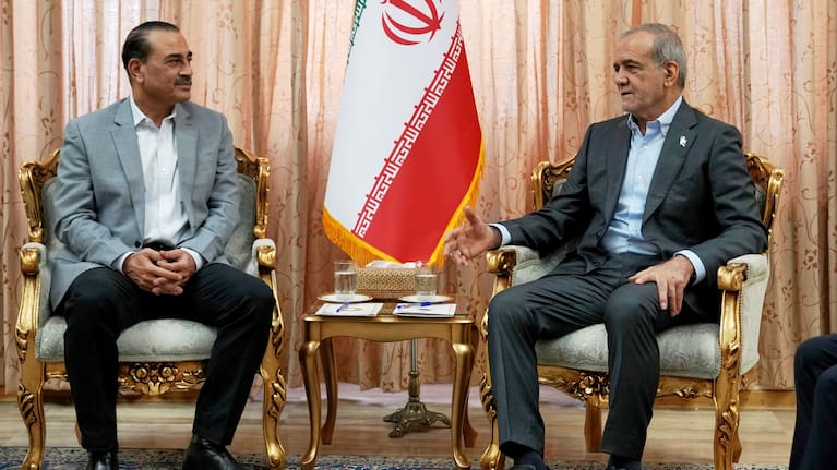 In this photo released by the Iranian Presidency Office, President Masoud Pezeshkian, right, speaks with Pakistan's Army Chief Field Marshal Gen. Asim Munir in Tehran, Iran, Saturday, May 23, 2026.