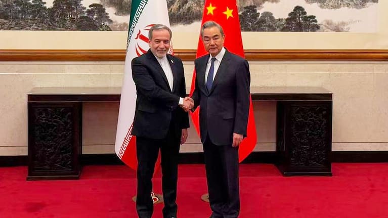 In this photo released by the Telegram channel of Iranian Foreign Minister Abbas Araghchi, China's Foreign Minister Wang Yi, right, meets with Iran's Foreign Minister Abbas Araghchi in Beijing, China