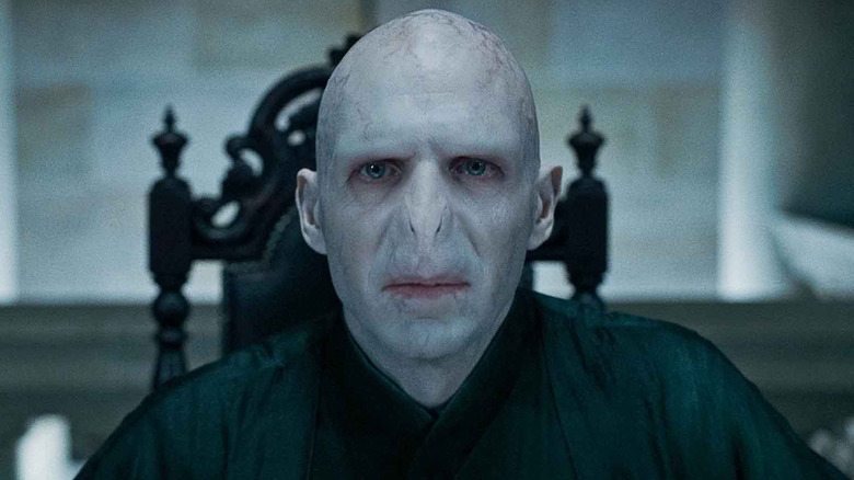 Voldemort sitting at a table in Harry Potter and the Deathly Hallows: Part 1