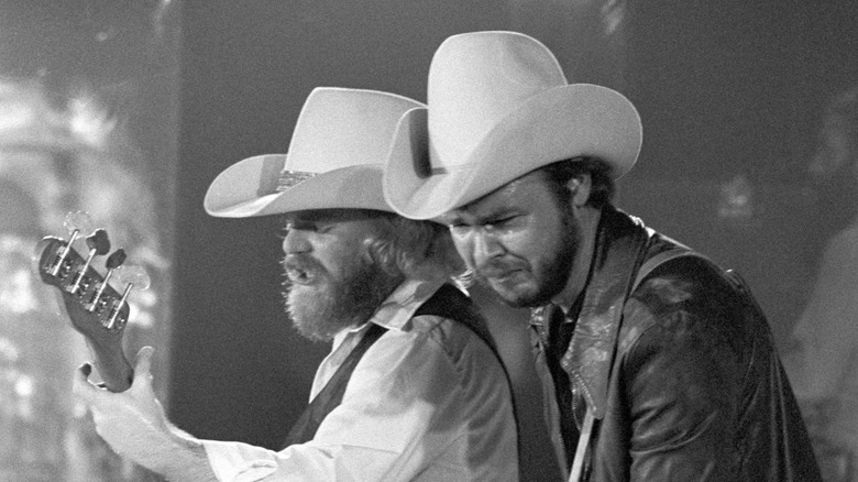 ZZ Top onstage with guitars in cowboy hats