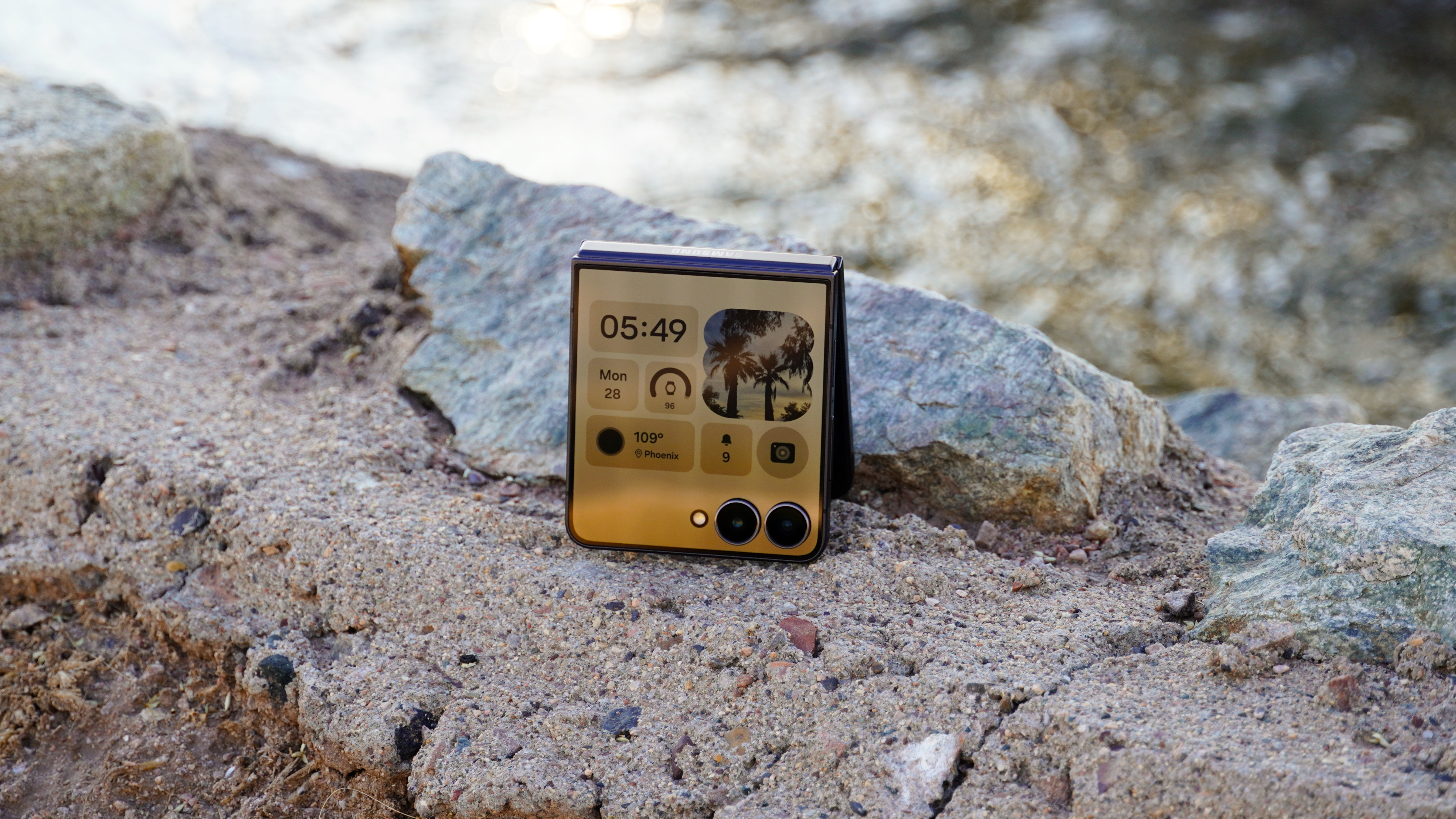 The Samsung Galaxy Z Flip 7 sitting near a stream.