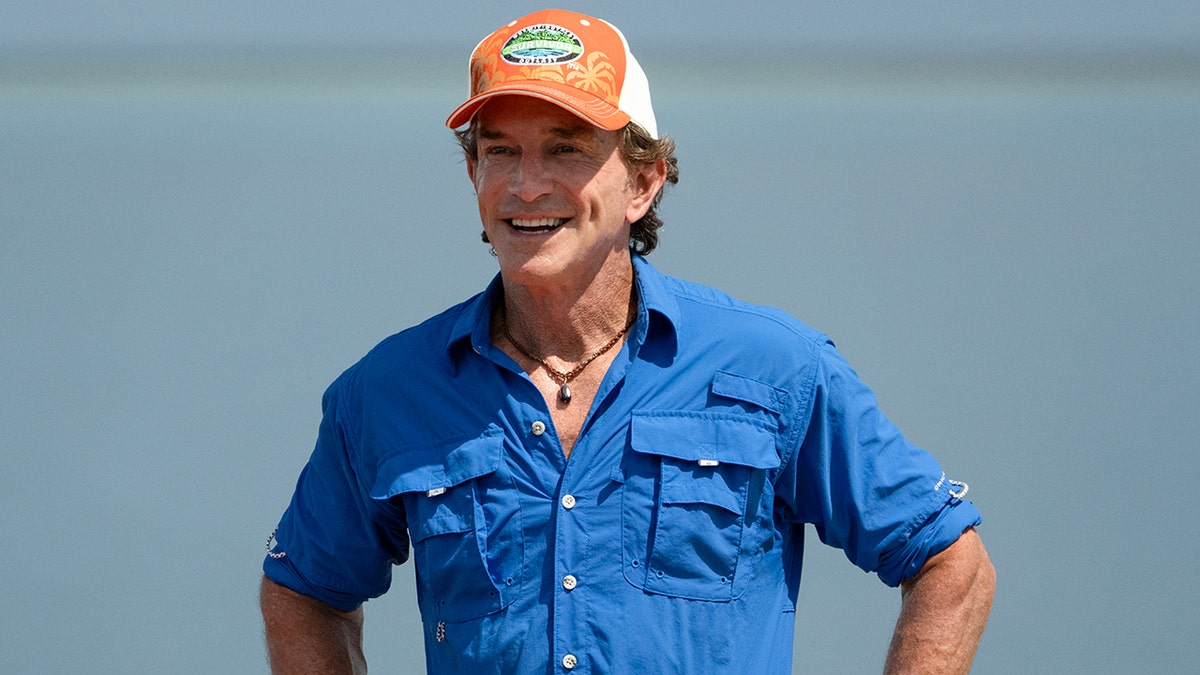 Jeff Probst standing on a beach filming Survivor in Fiji