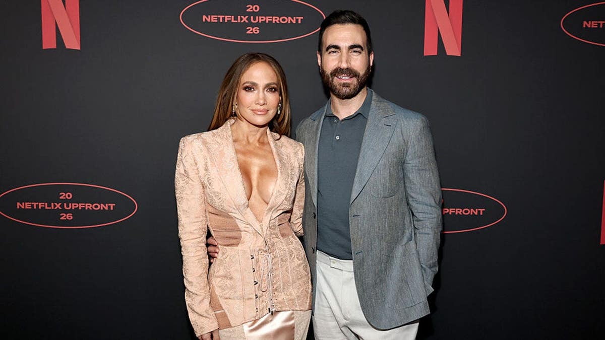 Jennifer Lopez and Brett Goldstein standing together at Netflix Upfront event in New York City