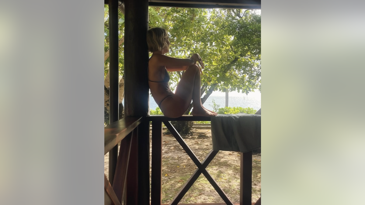 Julianne Hough sits on a porch